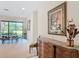 Hallway view showcasing a dining area, decorative art, and views of the outdoor scenery at 502 Canopy Ln, Lady Lake, FL 32159
