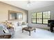 Cozy living room with a large window and comfortable seating arrangement at 502 Canopy Ln, Lady Lake, FL 32159