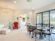 Open-concept living space with elegant dining set, comfortable seating, and access to the outdoors at 502 Canopy Ln, Lady Lake, FL 32159