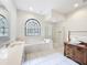 Bright main bathroom with soaking tub, glass shower, and double sink vanity at 502 Canopy Ln, Lady Lake, FL 32159