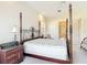 Main bedroom boasts a large four-poster bed and access to the main bathroom at 502 Canopy Ln, Lady Lake, FL 32159