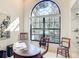 Well-lit office featuring a curved desk, large window, and comfortable seating for productivity at 502 Canopy Ln, Lady Lake, FL 32159