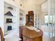 Office featuring a unique desk, built-in shelving with decor, and natural light at 502 Canopy Ln, Lady Lake, FL 32159