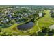 Overhead view featuring a community near a golf course and pond, surrounded by lush greenery and trees at 506 Golfpark Dr, Celebration, FL 34747