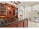 Home wet bar area featuring dark wood cabinetry and granite countertops at 506 Golfpark Dr, Celebration, FL 34747