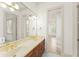 Bathroom with double vanity, large mirror and gold fixtures at 506 Golfpark Dr, Celebration, FL 34747