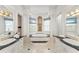 Luxurious bathroom featuring a soaking tub, double sinks, and elegant finishes for a spa-like experience at 506 Golfpark Dr, Celebration, FL 34747