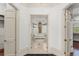 Hallway to the luxurious bathroom featuring a soaking tub with a window view at 506 Golfpark Dr, Celebration, FL 34747