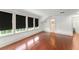 Bedroom with wood floors, three windows with shades, and an en suite bathroom at 506 Golfpark Dr, Celebration, FL 34747