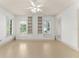 Spacious bedroom with built-in shelving, large windows, and a ceiling fan at 506 Golfpark Dr, Celebration, FL 34747