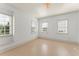 Empty bedroom with three large windows offering natural light and outdoor views at 506 Golfpark Dr, Celebration, FL 34747