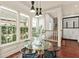 Bright dining area featuring large windows, modern lighting, and a glass-top table perfect for Gathering meals at 506 Golfpark Dr, Celebration, FL 34747