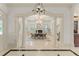 Open-concept dining area with stylish lighting, decorative columns, and adjoining living space at 506 Golfpark Dr, Celebration, FL 34747
