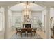 Elegant dining room with fireplace, modern chandelier, and abundant natural light at 506 Golfpark Dr, Celebration, FL 34747
