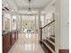 Stately foyer featuring tile flooring, white columns, and a view to the living room at 506 Golfpark Dr, Celebration, FL 34747