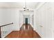 Bright hallway featuring hardwood floors and white molding at 506 Golfpark Dr, Celebration, FL 34747