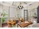 Chic home office with modern lighting, comfortable seating, and large windows overlooking the yard at 506 Golfpark Dr, Celebration, FL 34747