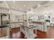 Spacious gourmet kitchen with stainless steel appliances, granite countertops, and custom island with a prep sink at 506 Golfpark Dr, Celebration, FL 34747
