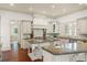 Bright, open kitchen with a large island, granite countertops, and custom cabinets offering ample storage at 506 Golfpark Dr, Celebration, FL 34747