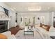 Comfortable living room features a fireplace, built-in shelves, and French doors to the outside at 506 Golfpark Dr, Celebration, FL 34747