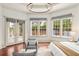 Sunlit main bedroom featuring large windows, elegant seating, and a cozy, inviting atmosphere at 506 Golfpark Dr, Celebration, FL 34747
