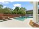 Backyard pool with brick accents, jacuzzi, and ample patio space at 506 Golfpark Dr, Celebration, FL 34747