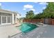 Pool area with a stone waterfall and brick fencing, located in a landscaped backyard at 506 Golfpark Dr, Celebration, FL 34747