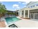 Beautiful pool and spa surrounded by a brick fence and lush landscaping at 506 Golfpark Dr, Celebration, FL 34747