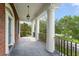 Elegant porch with stately columns, rod iron railing, and a view of the yard at 506 Golfpark Dr, Celebration, FL 34747