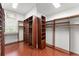 Spacious walk-in closet featuring wood shelving and hardwood floors at 506 Golfpark Dr, Celebration, FL 34747