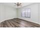 Comfortable bedroom featuring wood floors, a ceiling fan, and a window for natural light at 520 Via Verona Ln # 202, Altamonte Springs, FL 32714