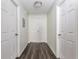 Hallway featuring wood floors, neutral paint, and access to several rooms in the home at 520 Via Verona Ln # 202, Altamonte Springs, FL 32714