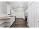An organized kitchen showcases white cabinets, appliances, plus durable laminate flooring at 520 Via Verona Ln # 202, Altamonte Springs, FL 32714