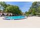 A luxurious community pool featuring comfortable lounge chairs and a pergola-covered seating area at 520 Via Verona Ln # 202, Altamonte Springs, FL 32714