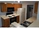 A kitchen with modern black appliances and wood cabinets at 5267 Images Cir # 102, Kissimmee, FL 34746