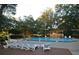Community swimming pool and chairs under a canopy of trees at 5267 Images Cir # 102, Kissimmee, FL 34746