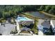 Scenic aerial view of the pool, clubhouse, and playground in a well-maintained community at 542 Pine Tree Bridge Trl, St Cloud, FL 34772