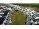Aerial view of a neighborhood park and homes, showcasing community layout and green spaces at 542 Pine Tree Bridge Trl, St Cloud, FL 34772