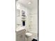 Well-lit bathroom features a shower-tub combo, gray vanity, and modern fixtures, offering a clean aesthetic at 542 Pine Tree Bridge Trl, St Cloud, FL 34772