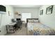 Cozy bedroom featuring a single bed, desk setup, and window offering natural light for a comfortable space at 542 Pine Tree Bridge Trl, St Cloud, FL 34772