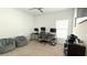 Bedroom featuring multiple computer desks, two gaming chairs, and a clean interior at 542 Pine Tree Bridge Trl, St Cloud, FL 34772