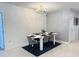 Elegant dining room with a stylish table set for six, modern chandelier, and neutral decor at 542 Pine Tree Bridge Trl, St Cloud, FL 34772