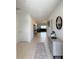 Bright hallway with sleek tile flooring, modern furnishings, and stylish decor, leading to the living areas at 542 Pine Tree Bridge Trl, St Cloud, FL 34772