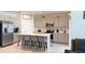Modern kitchen with stainless steel appliances, a quartz island with seating, and ample cabinet space at 542 Pine Tree Bridge Trl, St Cloud, FL 34772