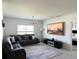 Cozy living room featuring a plush sectional sofa, modern lighting, and a large screen TV for entertainment at 542 Pine Tree Bridge Trl, St Cloud, FL 34772