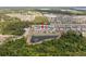 Wide aerial shot of homes and the surrounding community highlighting lush greenery and a pond at 5457 Carrara Ct, St Cloud, FL 34771