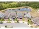Beautiful aerial view of homes featuring well-maintained landscaping and a scenic pond at 5457 Carrara Ct, St Cloud, FL 34771
