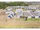A high aerial view showcasing the backyard, patio, and surrounding neighborhood at 5457 Carrara Ct, St Cloud, FL 34771