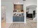 Stylish bar area boasting custom wood paneling, display shelves, and elegant cabinetry, perfect for entertaining at 5457 Carrara Ct, St Cloud, FL 34771