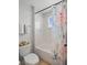 Bright bathroom featuring a tub and shower combination with white tile and modern fixtures at 5457 Carrara Ct, St Cloud, FL 34771